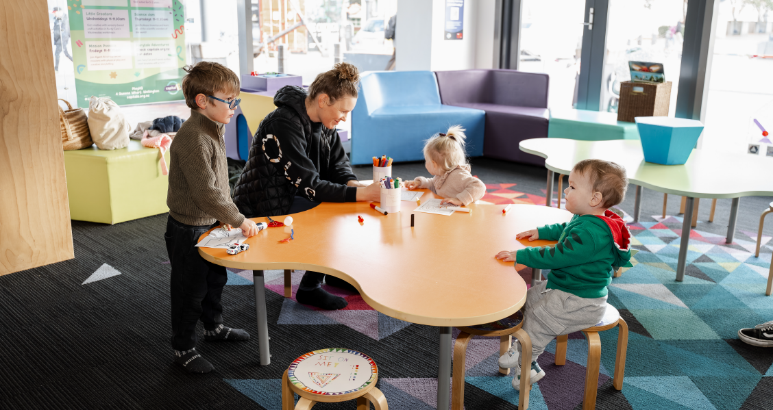 People sitting at the craft table in PlayHQ