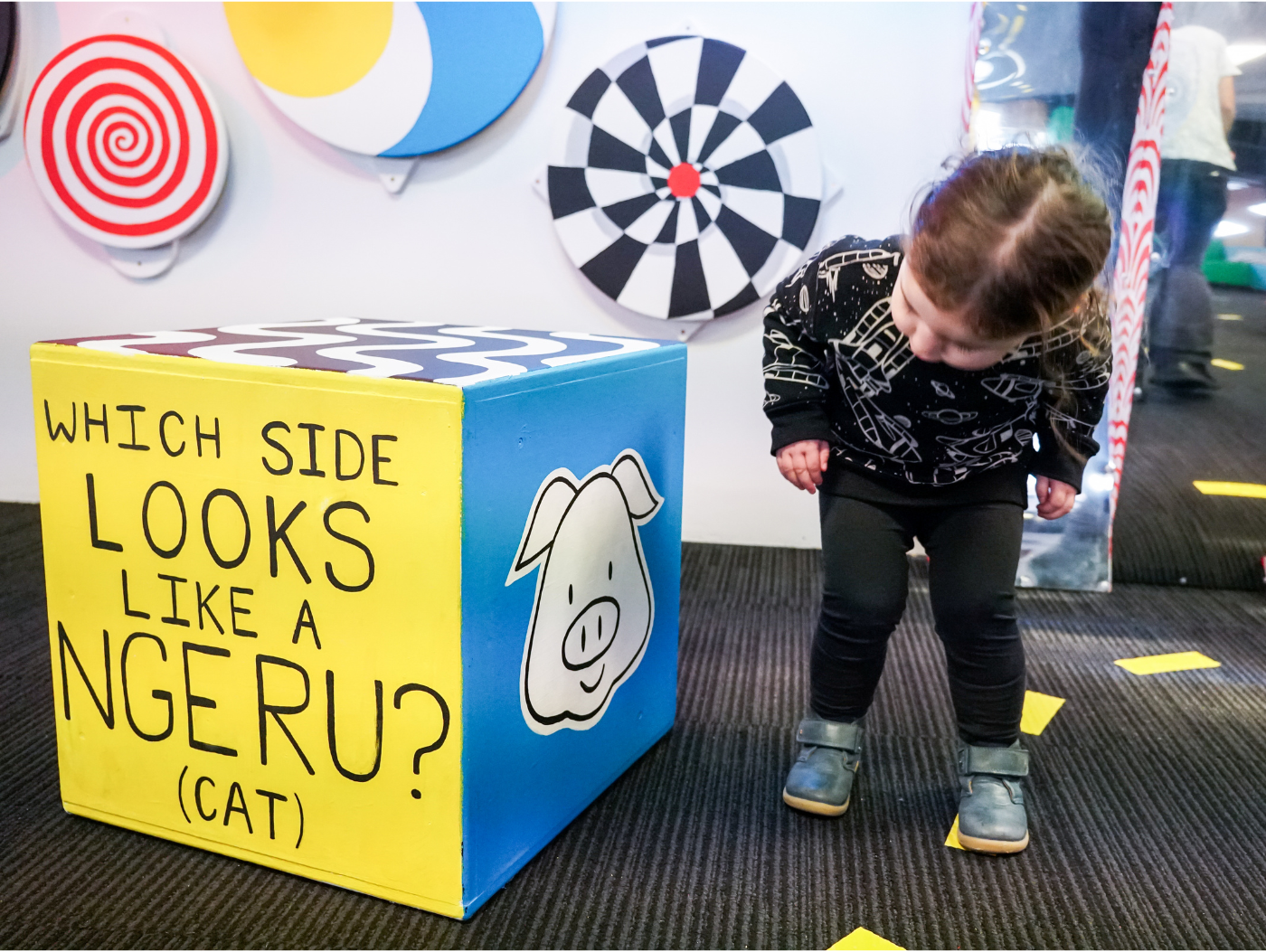 A child looking in Topsy Turvy looking at a conductive paint box.